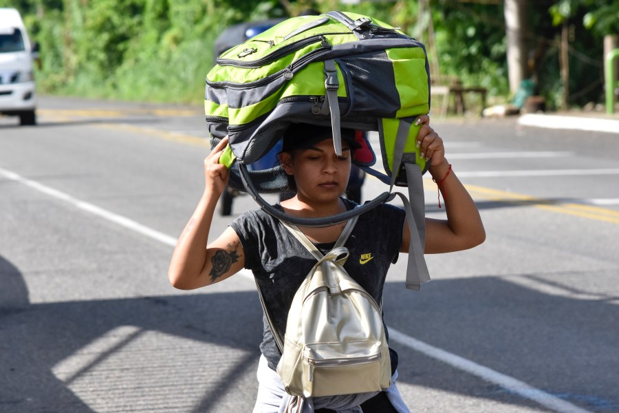 A migrant walks along the highway through Suchiate, Chiapas state in southern Mexico, Sunday, July 21, 2024, during their journey north toward the U.S. border. (AP Photo/Edgar H. Clemente)