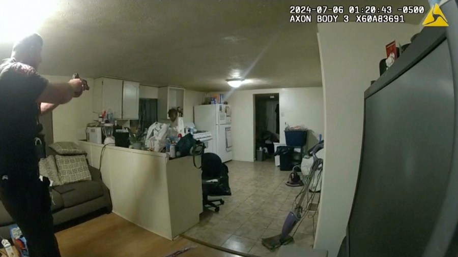 In this image taken from body camera video released by Illinois State Police on Monday, July 22, 2024, former Sangamon County Sheriff’s Deputy Sean Grayson, left, points his gun at Sonya Massey, who called 911 for help, before shooting and killing her inside her home in Springfield, Ill., July 6, 2024. (Illinois State Police via AP)