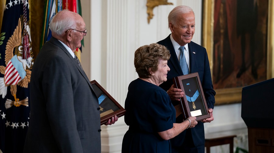 Theresa Chandler receives a Medal of Honor posthumously for U.S. Army Pvt. George Davenport Wilson from President Biden at the White House.