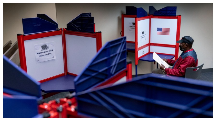 A voter fills out his ballot at an early voting location.