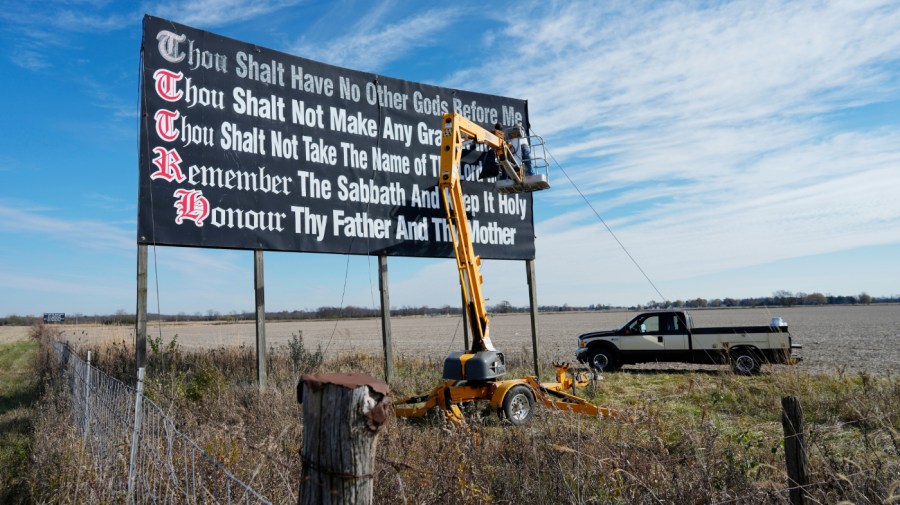 Workers repaint a Ten Commandments billboard off of Interstate 71 on Election Day near Chenoweth, Ohio, Tuesday, Nov. 7, 2023. Louisiana has become the first state to require that the Ten Commandments be displayed in every public school classroom under a bill signed into law by Republican Gov. Jeff Landry on Wednesday. (AP Photo/Carolyn Kaster, File)