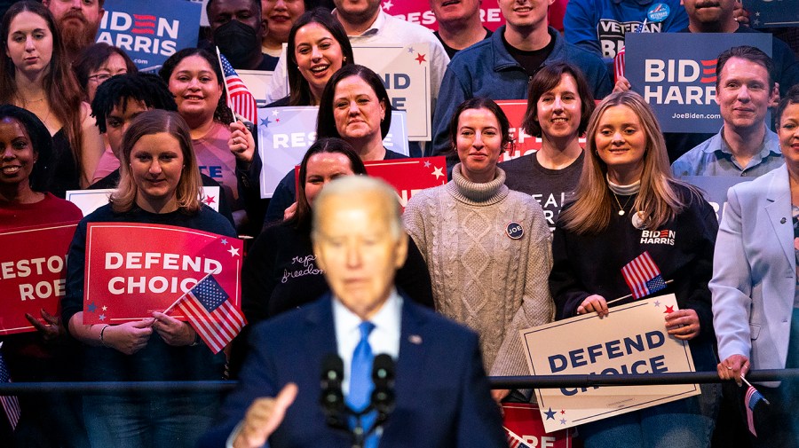 Supporters are seen behind President Biden