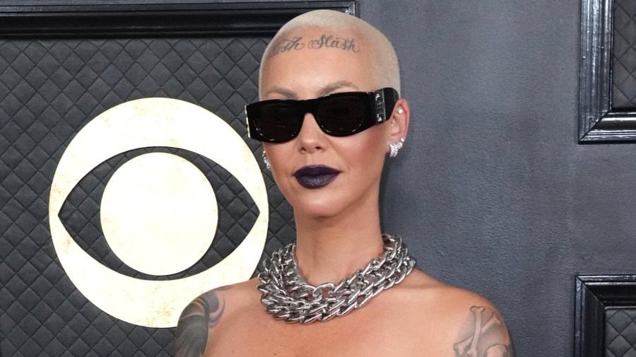 Amber Rose poses for a photo in front of a CBS logo.