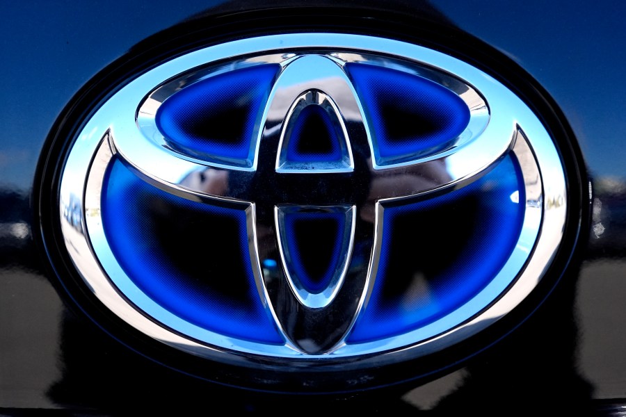 FILE - Toyota logo (Hybrid model) is seen at a new and used vehicles dealership in Palatine, Ill., Tuesday, March 20, 2024. Toyota reported Thursday, Aug. 1, that its April-June profit rose 1.7%, boosted by a favorable exchange rate, as vehicle sales grew around the world despite a certification scandal that halted production in Japan for several months. (AP Photo/Nam Y. Huh, File)