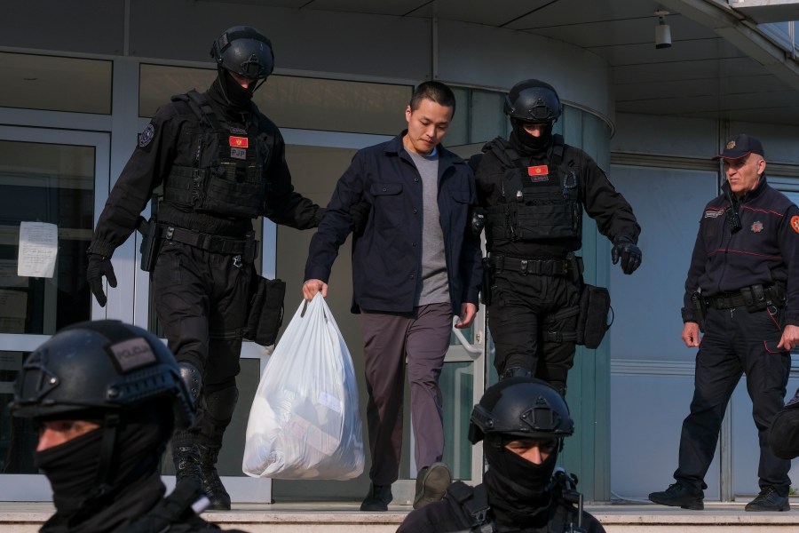 FILE - Montenegrin police officers escort South Korean citizen, Terraform Labs founder Do Kwon, center, in Montenegro's capital Podgorica, March 23, 2024. A Montenegrin appeals court on Thursday, Aug. 1, upheld a ruling by a lower court to hand over the South Korean mogul known as “the cryptocurrency king” to his native country, rejecting a bid to extradite him to the United States. (AP Photo/Risto Bozovic, File)