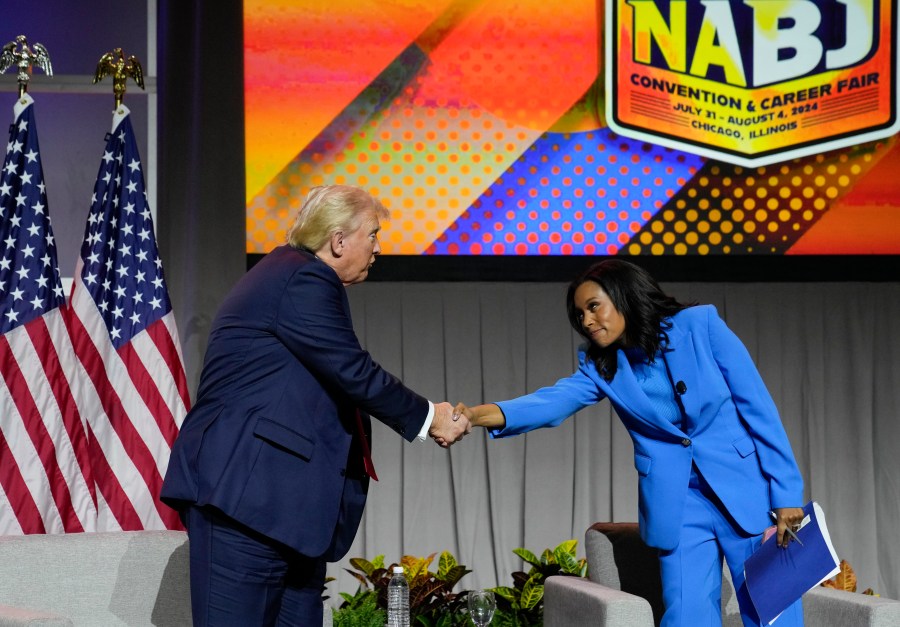 Republican presidential candidate former President Donald Trump shakes hands with ABC's Rachel Scott, at the National Association of Black Journalists, NABJ, convention, Wednesday, July 31, 2024, in Chicago. (AP Photo/Charles Rex Arbogast)