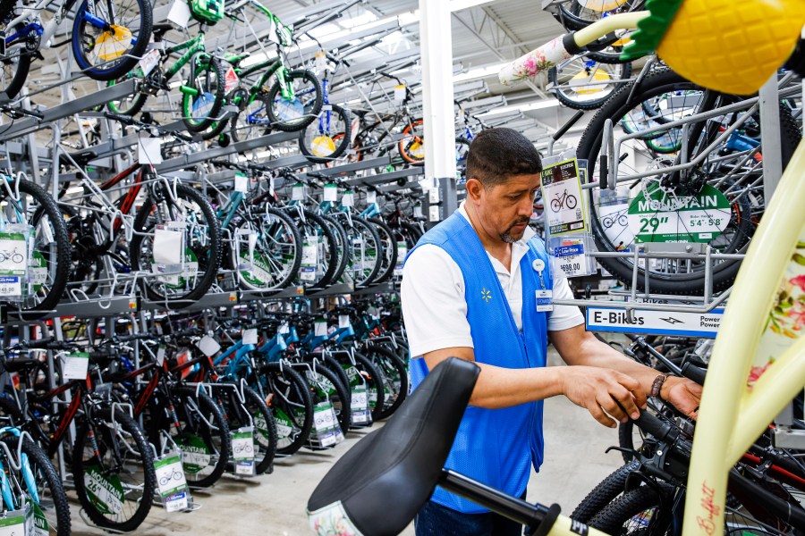 FILE - A worker organizes bicycles at a Walmart Superstore in Secaucus, New Jersey, July 11, 2024. Last month's rise in the unemployment rate has set off new worries about the threat of a recession, but it could also be a false alarm. The distorted post-pandemic economy has already confounded a host of traditional recession signals, at least so far. (AP Photo/Eduardo Munoz Alvarez, File)