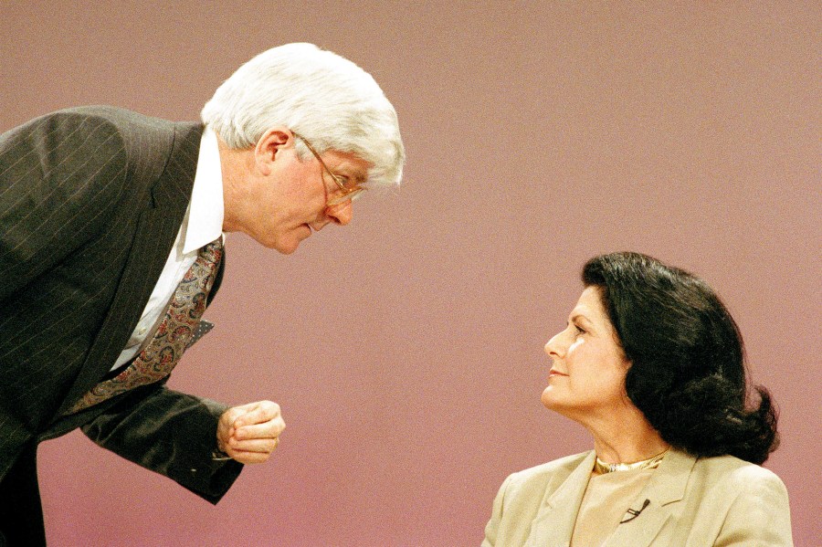 FILE - Judith Exner, one-time mistress of the late President John F. Kennedy, talks with television talk show host Phil Donahue during the show in Burbank, Calif., Feb. 26, 1988. Donahue, whose pioneering daytime talk show launched an indelible television genre, has died. He was 88.(AP Photo/Nick Ut, File)