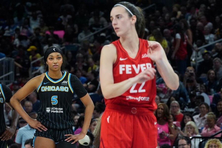 Chicago Sky forward Angel Reese, left, watches Indiana Fever guard Caitlin Clark take a free throw during the second half of a WNBA basketball game Friday, Aug. 30, 2024, in Chicago. (AP Photo/Erin Hooley)