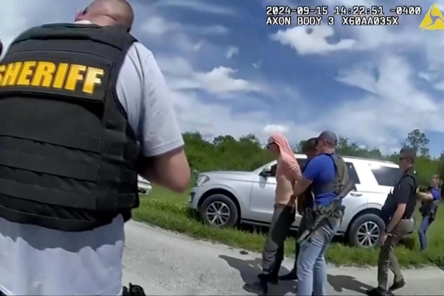 In this image taken from police body camera video and released by the Martin County, Fla., Sheriff’s Office, law enforcement officers arrest Ryan Routh, the man suspected in the apparent assassination attempt of Donald Trump, Sunday, Sept. 15, 2024. (Martin County Sheriff’s Office via AP)