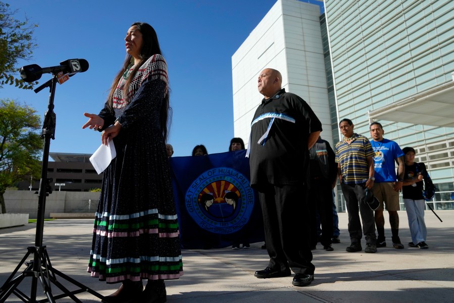 Ka-Voka Jackson, left, director of cultural resources for the Hualalpai Tribe, speaks during a news conference in front of U.S. District Court as she joins other members of the Hualapai Tribe, including Duane Clark, chairman of the Hualapai Tribe, as they gathered to try to persuade a federal judge to extend a temporary ban on exploratory drilling for a lithium project Tuesday, Sept. 17, 2024, in Phoenix. (AP Photo/Ross D. Franklin)