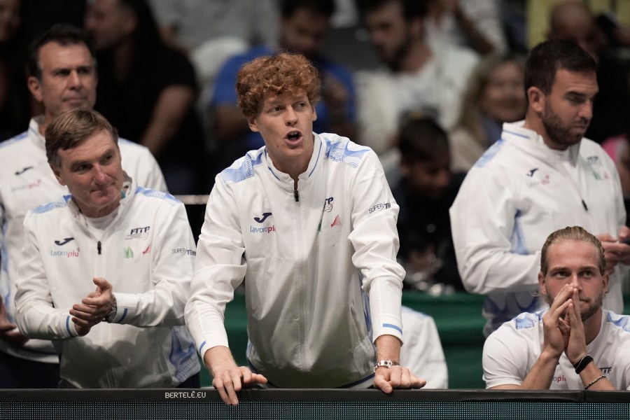 Italy's Jannick Sinner, center, shouts indications to Italy's Matteo Berrettini during a men's singles tennis Davis Cup tennis match between Berrettini and Botic Van Zandschulp of the Netherlands, at the Unipol arena, in Bologna, Italy, Sunday, Sept. 15, 2024. (Michele Nucci/LaPresse via AP)