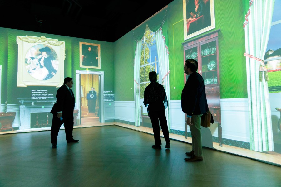 White House Historical Association President Stewart McLaurin tour members of the media in an interactive 3D room of the White House Green Room as is today, shown at The People's House exhibit, Monday, Sept. 16, 2024 in Washington. (AP Photo/Jose Luis Magana)