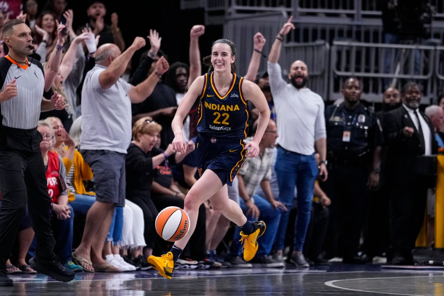 Indiana Fever guard Caitlin Clark (22) smiles after gabbing her tenth rebound in the closing seconds of a games against the Los Angeles Sparks in the second half of a WNBA basketball game in Indianapolis, Wednesday, Sept. 4, 2024. The rebound gave Clark a triple-double for the game. (AP Photo/Michael Conroy)