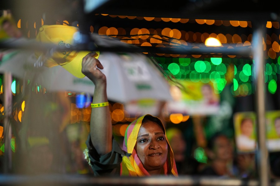 A woman listens to Sajith Premadasa, unseen, the presidential candidate and opposition leader of the Samagi Jana Balawgaya or United People's Power party, at an election rally, in Colombo, Sri Lanka, Wednesday, Sept. 18, 2024. (AP Photo/Rajesh Kumar Singh)