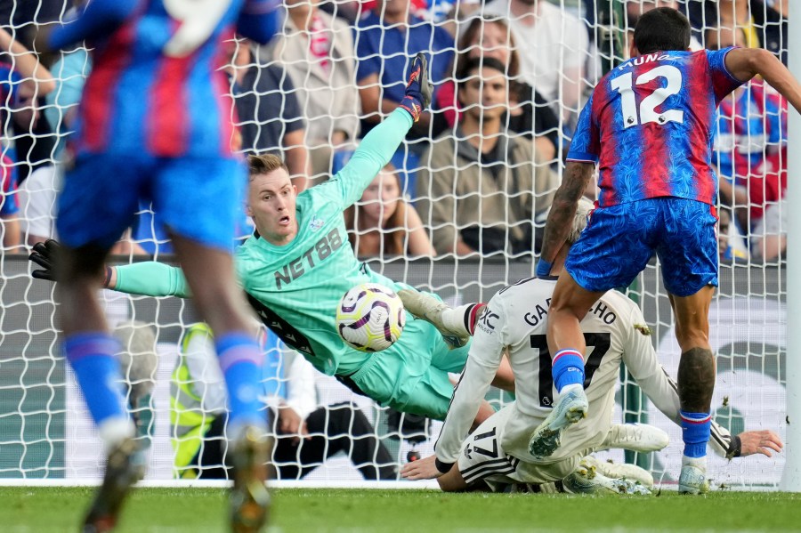 Crystal Palace's goalkeeper Dean Henderson goes for a save in front of Manchester United's Alejandro Garnacho during the English Premier League soccer match between Crystal Palace and Manchester United at Selhurst Park in London, Saturday, Sept. 21, 2023. (AP Photo/Kin Cheung)