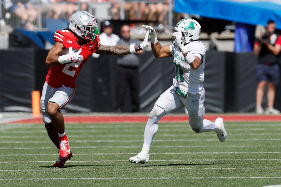 Ohio State receiver Emeka Egbuka, left, tries to stiff arm Marshall defensive back J.J. Roberts during the first half of an NCAA college football game Saturday, Sept. 21, 2024, in Columbus, Ohio. (AP Photo/Jay LaPrete)