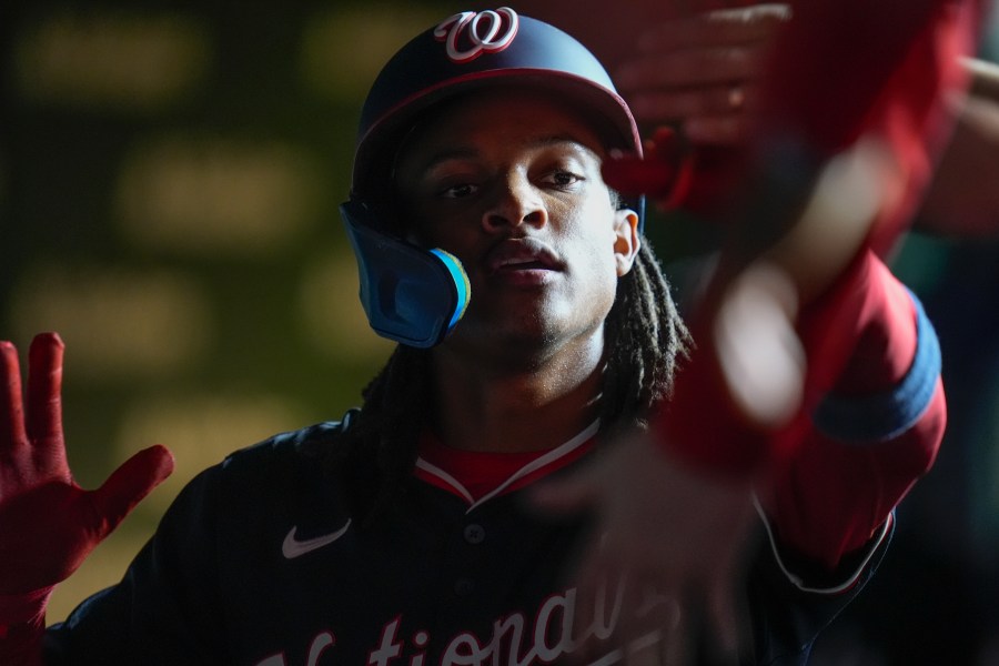 Washington Nationals' CJ Abrams celebrates after scoring on a double from James Wood during the third inning of a baseball game against the Chicago Cubs, Thursday, Sept. 19, 2024, in Chicago. (AP Photo/Erin Hooley)