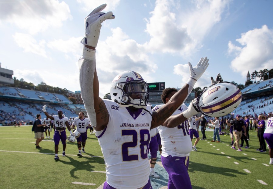 James Madison running back Jobi Malary (28) celebrates with fans after an NCAA college football game against North Carolina in Chapel Hill, N.C., Saturday, Sept. 21, 2024. (Daniel Lin/Daily News-Record via AP)