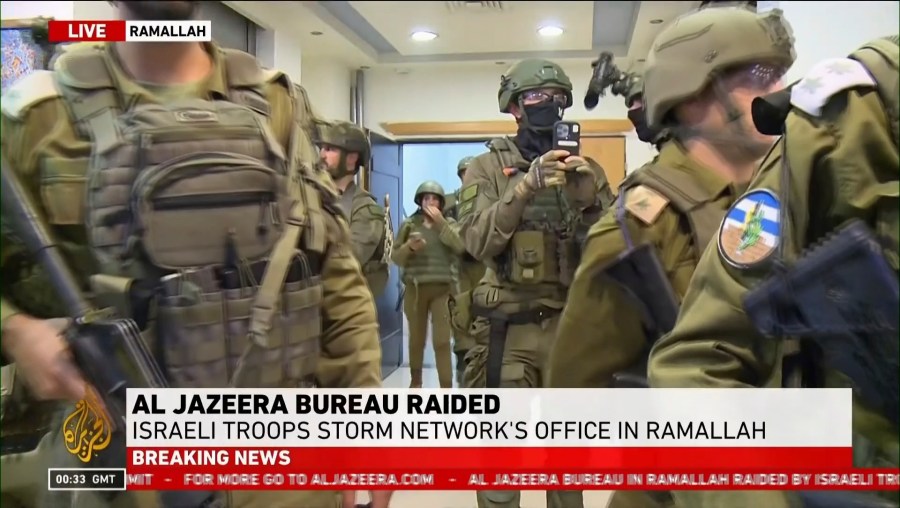 This image made from video provided by Al Jazeera English shows Israeli troops raiding their bureau in Ramallah, West Bank, Sunday, Sept. 22, 2024. (Al Jazeera via AP)