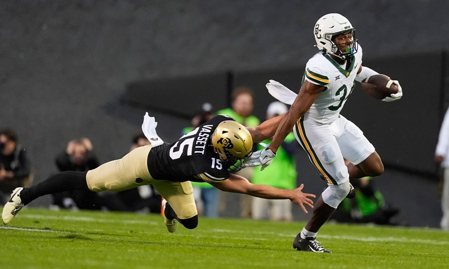 Baylor punt returner Josh Cameron, right, slips away from Colorado's Mark Vassett for a long return in the first half of an NCAA college football game Saturday, Sept. 21, 2024, in Boulder, Colo. (AP Photo/David Zalubowski)