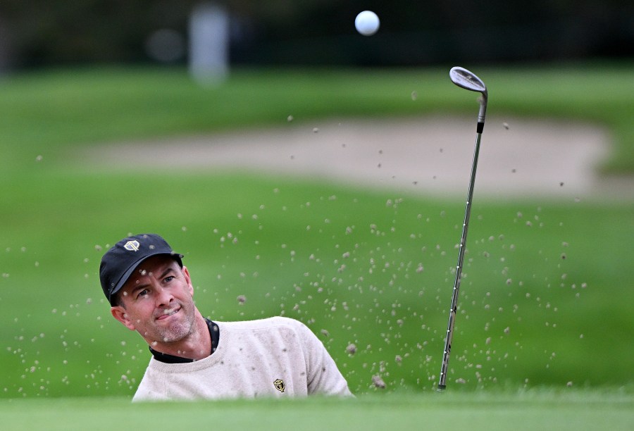 International team member Adam Scott, of Australia, plays a shot from a bunker during a practice round at the Presidents Cup golf tournament at Royal Montreal Golf Club in Montreal, Tuesday, Sept. 24, 2024. (Graham Hughes/The Canadian Press via AP)