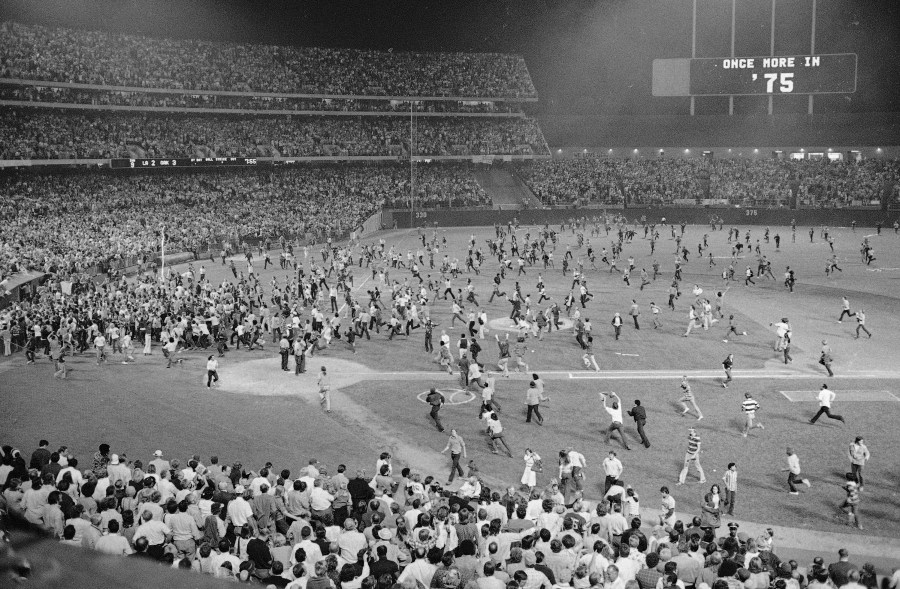 FILE - Fans pour onto the field at the Oakland Coliseum after the Oakland A's beat the Los Angeles Dodgers 3-2 and won their third straight World Series, Oct. 17, 1974, in Oakland. (AP Photo, File)