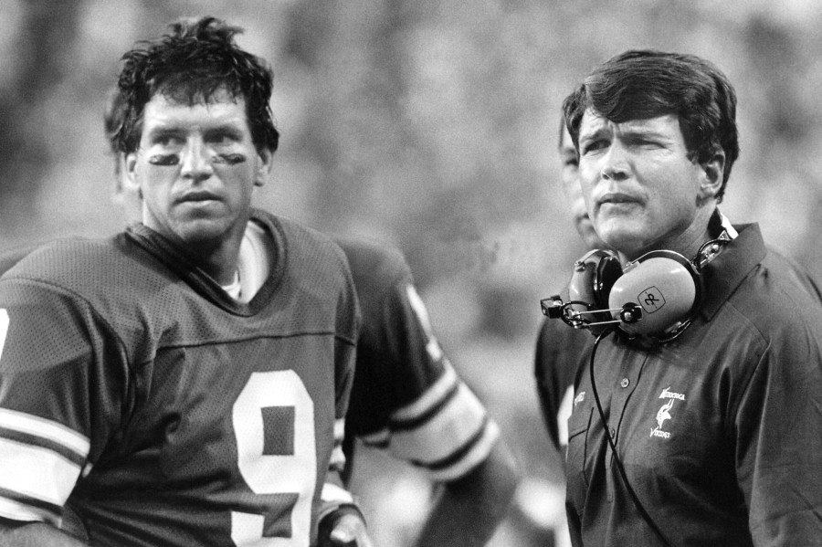 FILE - Minnesota Vikings head coach Les Steckel and quarterback Tommy Kramer, left, survey the damage from the sidelines as they watch the San Diego Chargers ruin Steckel's coaching debut with a 42-13 rout in Minneapolis, Sept. 3, 1984. (AP Photo/Larry Salzman, File)