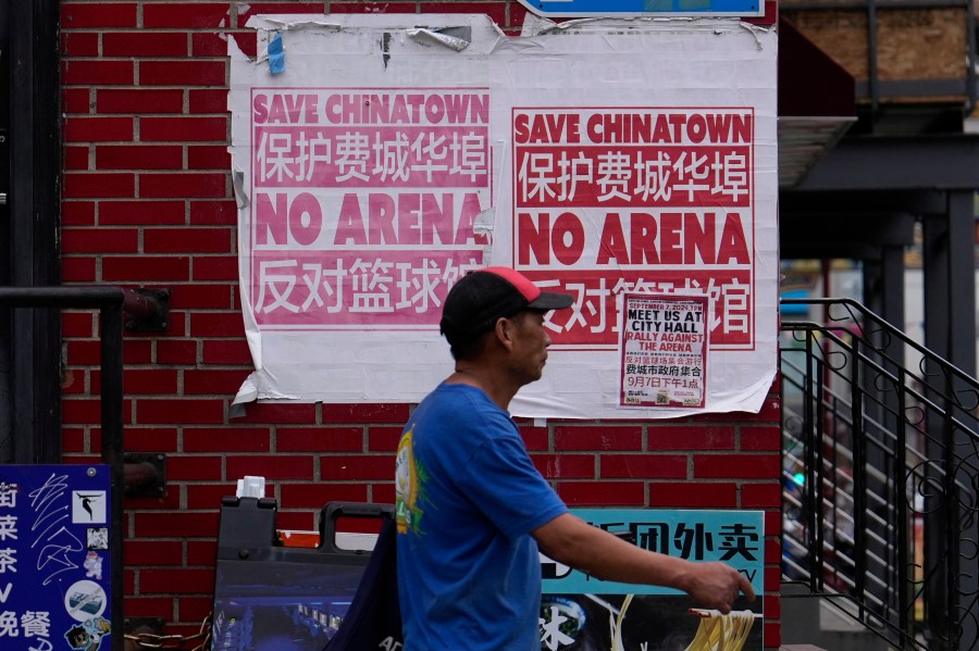 A man walks through the Chinatown neighborhood of Philadelphia, Wednesday, Sept. 18, 2024. (AP Photo/Matt Slocum)