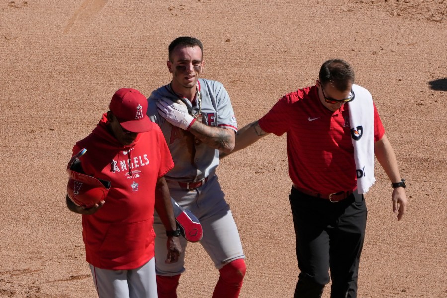 Los Angeles Angels' Zach Neto holds his shoulder as he heads to the dugout after being caught trying to steal second during the fourth inning of a baseball game against the Chicago White Sox on Thursday, Sept. 26, 2024, in Chicago. (AP Photo/Charles Rex Arbogast)