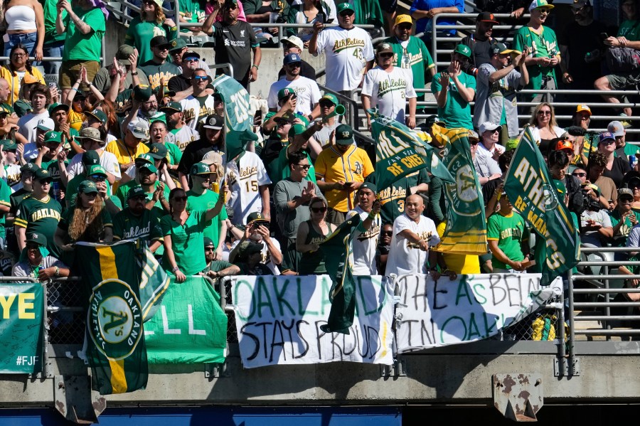 Oakland Athletics fans cheer during the eighth inning of a baseball game against the Texas Rangers, Thursday, Sept. 26, 2024, in Oakland, Calif. (AP Photo/Godofredo A. Vásquez)