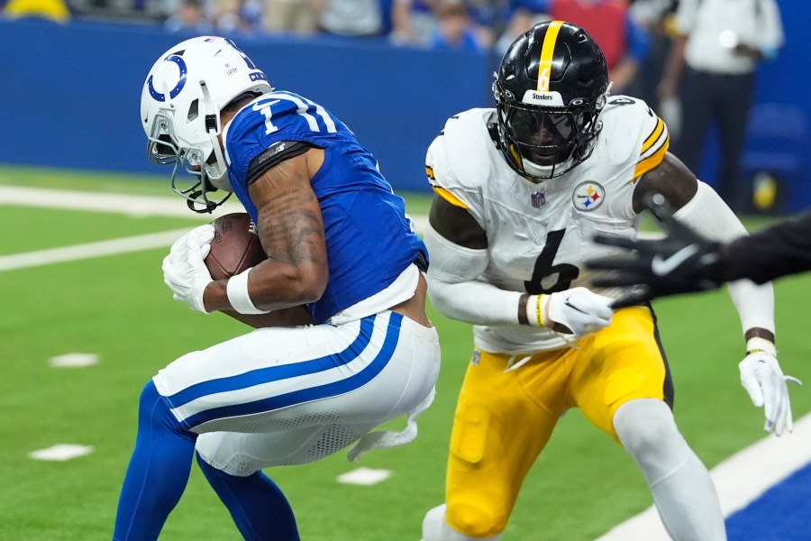 Indianapolis Colts wide receiver Josh Downs (1) backs into the end zone for a touchdown with Pittsburgh Steelers linebacker Patrick Queen (6) defending during the first half of an NFL football game Sunday, Sept. 29, 2024, in Indianapolis. (AP Photo/Darron Cummings)