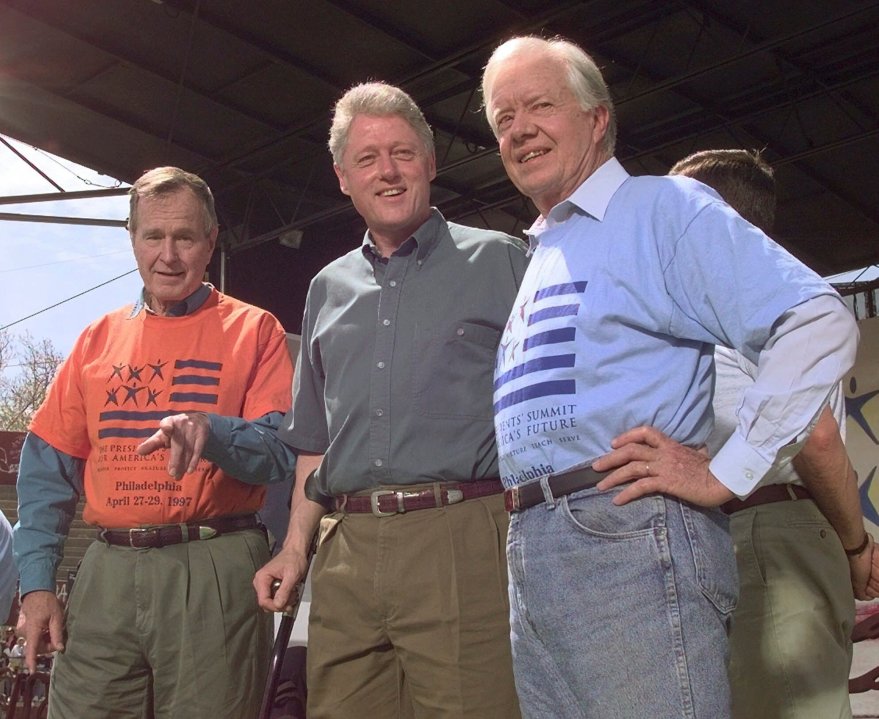 FILE - Former Presidents George Bush, left, and Jimmy Carter, right, stand with President Clinton during a kick-off rally for the President's volunteer summit at Marcus Foster Stadium in Philadelphia, PA., April 27, 1997. (AP Photo/Greg Gibson, File)