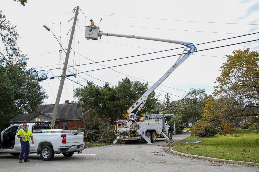 A Dominion Energy lineman works on a power line in the aftermath of Hurricane Helene Sunday, Sept. 29, 2024, in North Augusta, S.C. (AP Photo/Artie Walker Jr.)