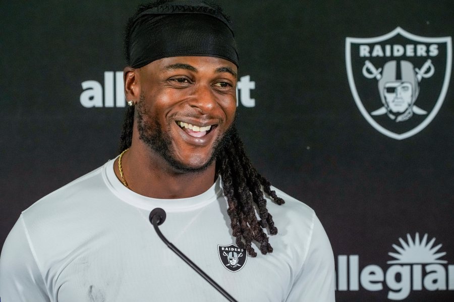 FILE - Las Vegas Raiders wide receiver Davante Adams (17) takes questions from the media after a NFL football training camp at Jack R. Hammett Sports Complex in Costa Mesa, Calif., July 24, 2024. (AP Photo/Damian Dovarganes, File)