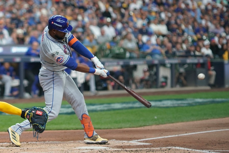 New York Mets' Starling Marte hits an RBI sacrifice fly ball during the second inning of Game 2 of a National League wild card baseball game against the Milwaukee Brewers Tuesday, Oct. 1, 2024, in Milwaukee. (AP Photo/Morry Gash)