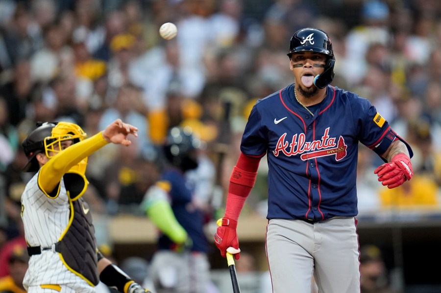 Atlanta Braves' Orlando Arcia reacts after dodging an inside pitch during the third inning in Game 1 of an NL Wild Card Series baseball game against the San Diego Padres, Tuesday, Oct. 1, 2024, in San Diego. (AP Photo/Gregory Bull)