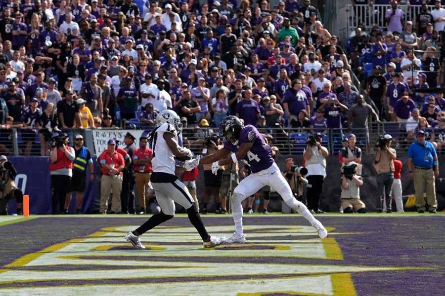 Las Vegas Raiders wide receiver Davante Adams, left, catches a touchdown pass against Baltimore Ravens cornerback Marlon Humphrey (44) during the second half of an NFL football game, Sunday, Sept. 15, 2024, in Baltimore. (AP Photo/Stephanie Scarbrough)