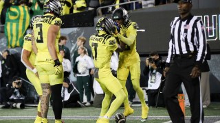 Oregon Ducks wide receiver Tez Johnson, right, celebrates after scoring a touchdown with teammates Dillon Gabriel, Terrance Ferguson, and Evan Stewart during the second half of an NCAA college football game, Friday, Oct. 4, 2024, in Eugene, Ore. (AP Photo/Amanda Loman)