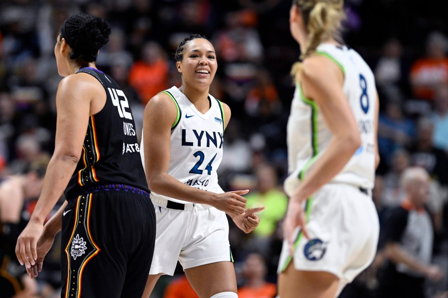 Minnesota Lynx forward Napheesa Collier (24) smiles at forward Alanna Smith (8) during the second half of a WNBA basketball semifinal game against the Connecticut Sun, Friday, Oct. 4, 2024, in Uncasville, Conn. (AP Photo/Jessica Hill)