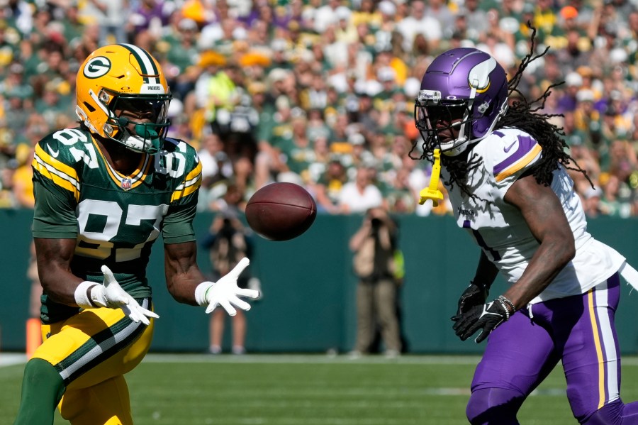 Green Bay Packers wide receiver Romeo Doubs (87) makes a catch past Minnesota Vikings cornerback Shaq Griffin, right, during the first half of an NFL football game Sunday, Sept. 29, 2024, in Green Bay, Wis. (AP Photo/Morry Gash)