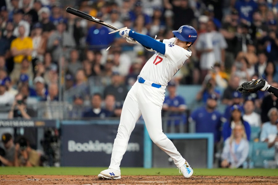 Los Angeles Dodgers' Shohei Ohtani breaks his bat as he singles during the fourth inning in Game 1 of baseball's NL Division Series against the San Diego Padres, Saturday, Oct. 5, 2024, in Los Angeles. (AP Photo/Ashley Landis)