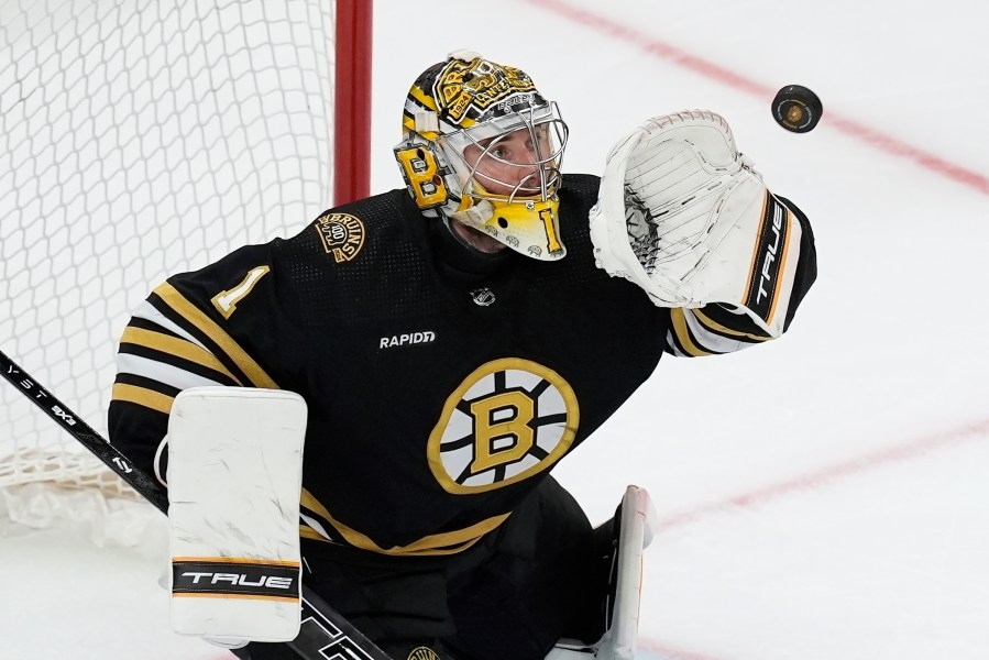 FILE - Boston Bruins' Jeremy Swayman makes a glove save during the third period in Game 6 of an NHL hockey Stanley Cup second-round playoff series against the Florida Panthers, May 17, 2024, in Boston. (AP Photo/Michael Dwyer, File)