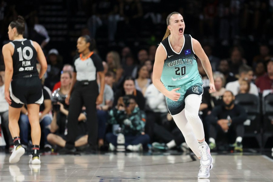 New York Liberty guard Sabrina Ionescu (20) reacts after a three-point- basket during the first half of a WNBA Semifinal basketball game, Sunday, Oct. 6, 2024, in Las Vegas. (AP Photo/Ian Maule)