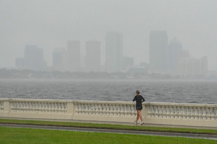 A jogger trots in light rain ahead of the arrival of Hurricane Milton, Wednesday, Oct. 9, 2024, in Tampa, Fla. (AP Photo/Julio Cortez)