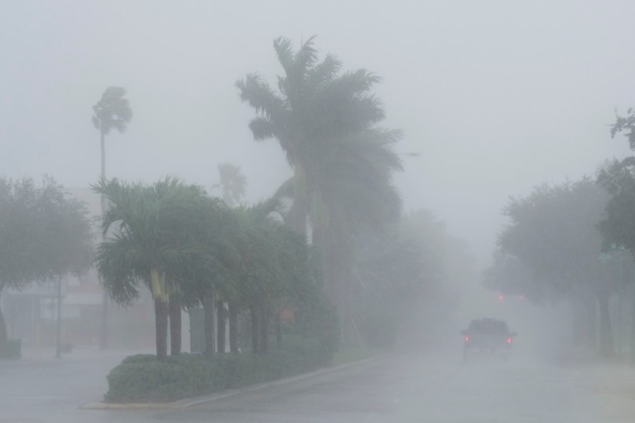 A Lee County Sheriff's officer patrols the streets of Cape Coral, Fla., as heavy rain falls ahead of Hurricane Milton, Wednesday, Oct. 9, 2024. (AP Photo/Marta Lavandier)