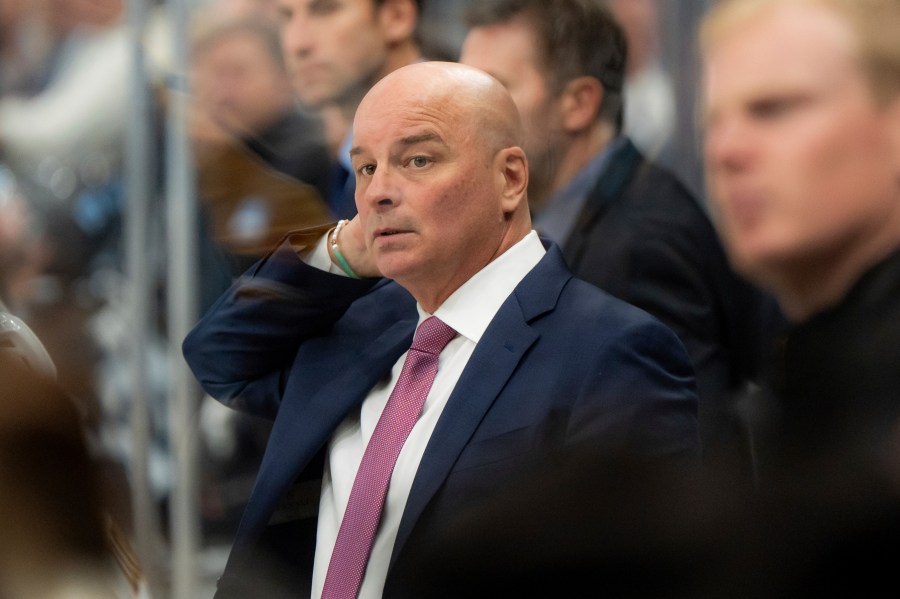 Boston Bruins head coach Jim Montgomery watches the action during the second period of an NHL hockey game against the Utah Hockey Club, Saturday, Oct. 19, 2024, in Salt Lake City. (AP Photo/Spenser Heaps)