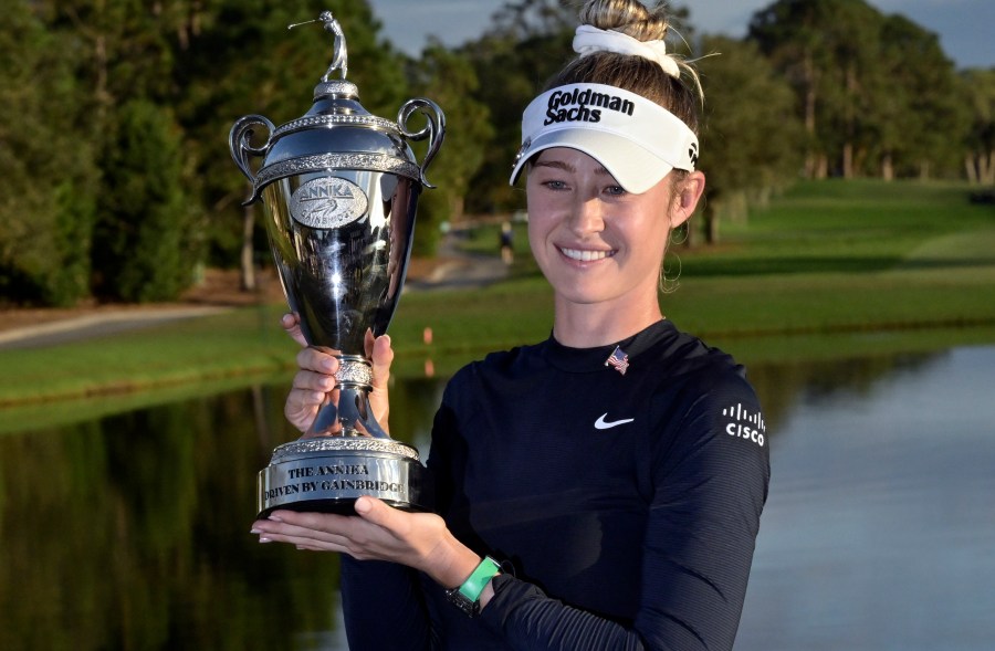 Nelly Korda holds the championship trophy after winning the the LPGA Annika golf tournament at Pelican Golf Club, Sunday, Nov. 17, 2024, in Belleair, Fla. (AP Photo/Steve Nesius)