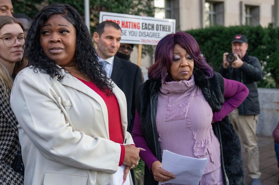 FILE - Wandrea "Shaye" Moss, left, and her mother Ruby Freeman, right, leave after speaking with reporters outside federal court, Dec. 15, 2023, in Washington. (AP Photo/Alex Brandon, File)