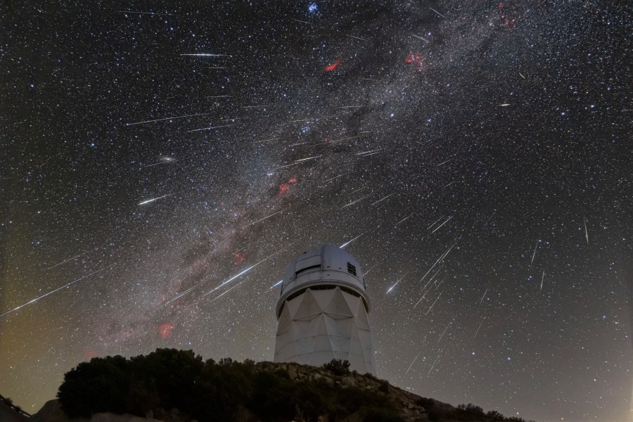 CORRECTS LOCATION TO 56 MILES SOUTHWEST OF TUCSON NOT IN TUCSON This Dec. 14, 2023 image made available by NOIRLab shows meteors from the Geminid meteor shower streaking across the sky above the Nicholas U. Mayall Telescope at Kitt Peak National Observatory (KPNO), a Program of NSF's NOIRLab, located about 56 miles (90 kilometers) southwest of Tucson in the Tohono O’odham Nation. (NSF's NOIRLab via AP)